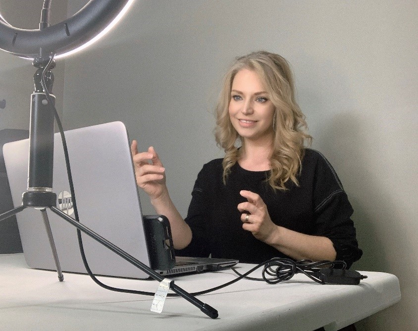 A female sitting in front of a computer providing ASL services