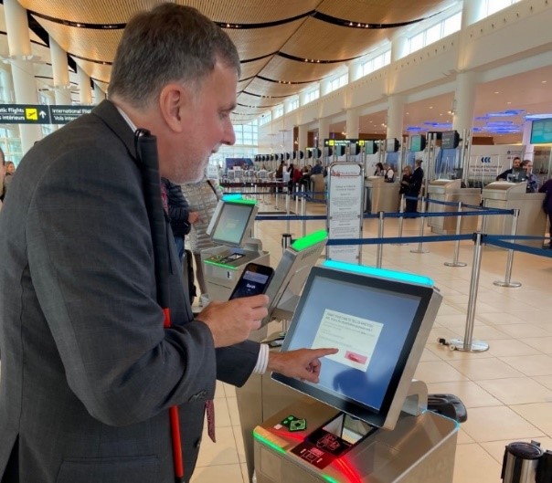 Man interacting with terminal in a airport